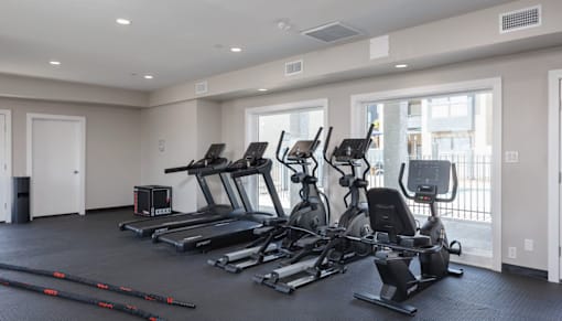 A spacious gym with treadmills, elliptical machines, and other exercise equipment.